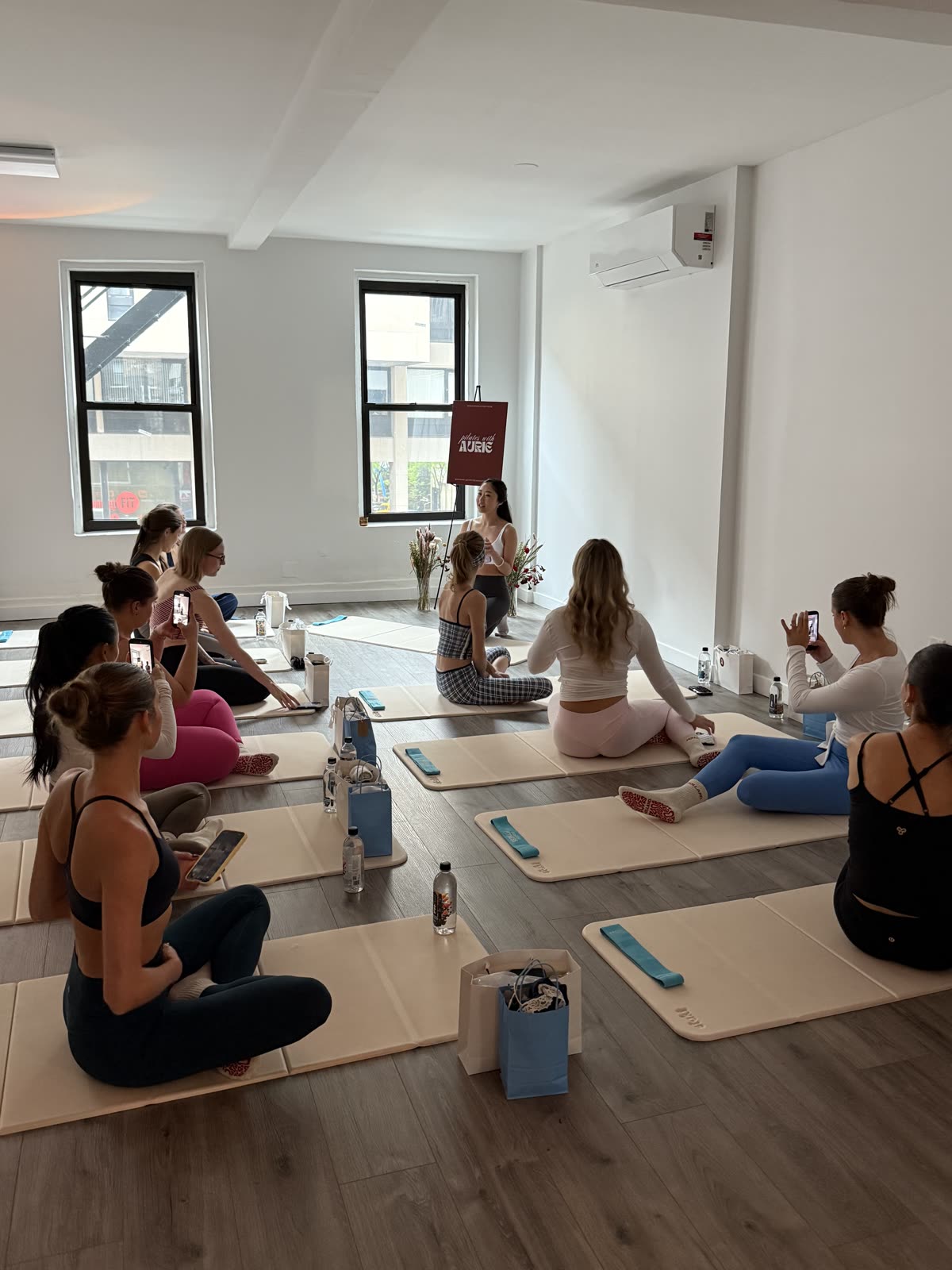 A group sitting together on mats between sets