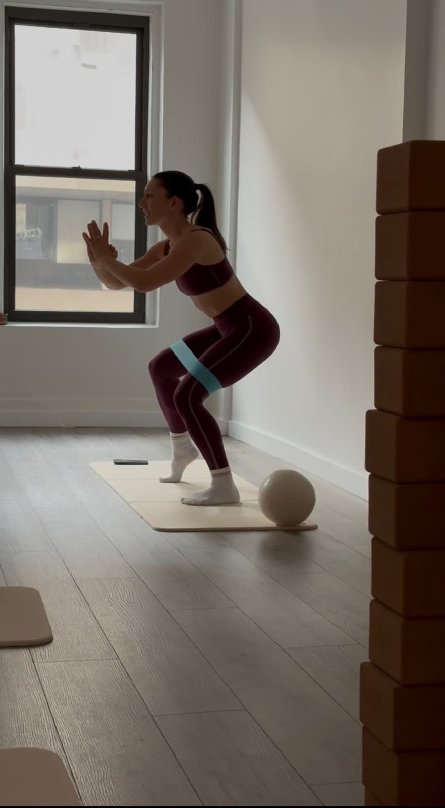 A host leading a small pilates class at stayfor Studio